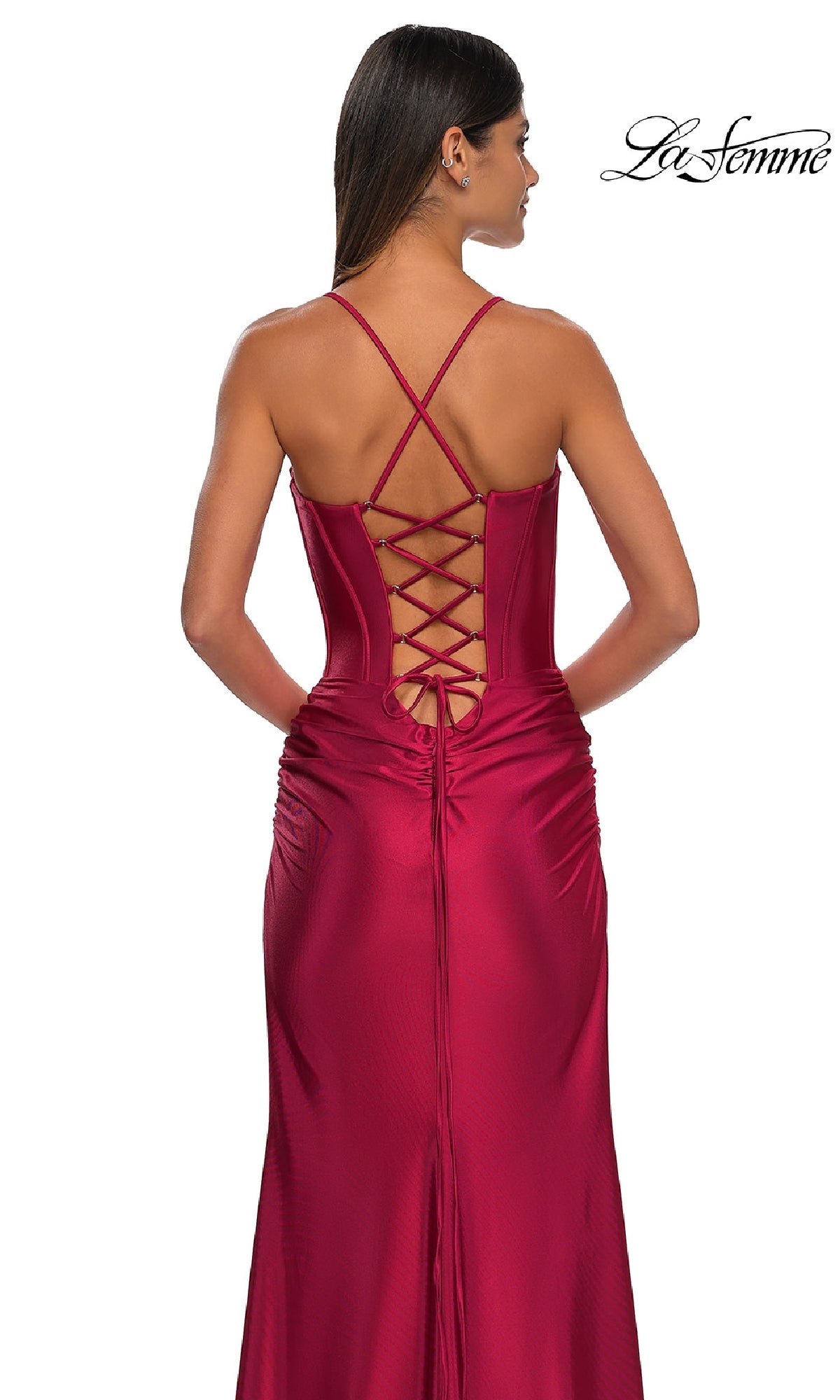 Woman in the La Femme 32683 Lace-Up Long Satin Prom Dress in deep red, featuring a corset-style bodice, crisscross lace-up back, and spaghetti straps. The